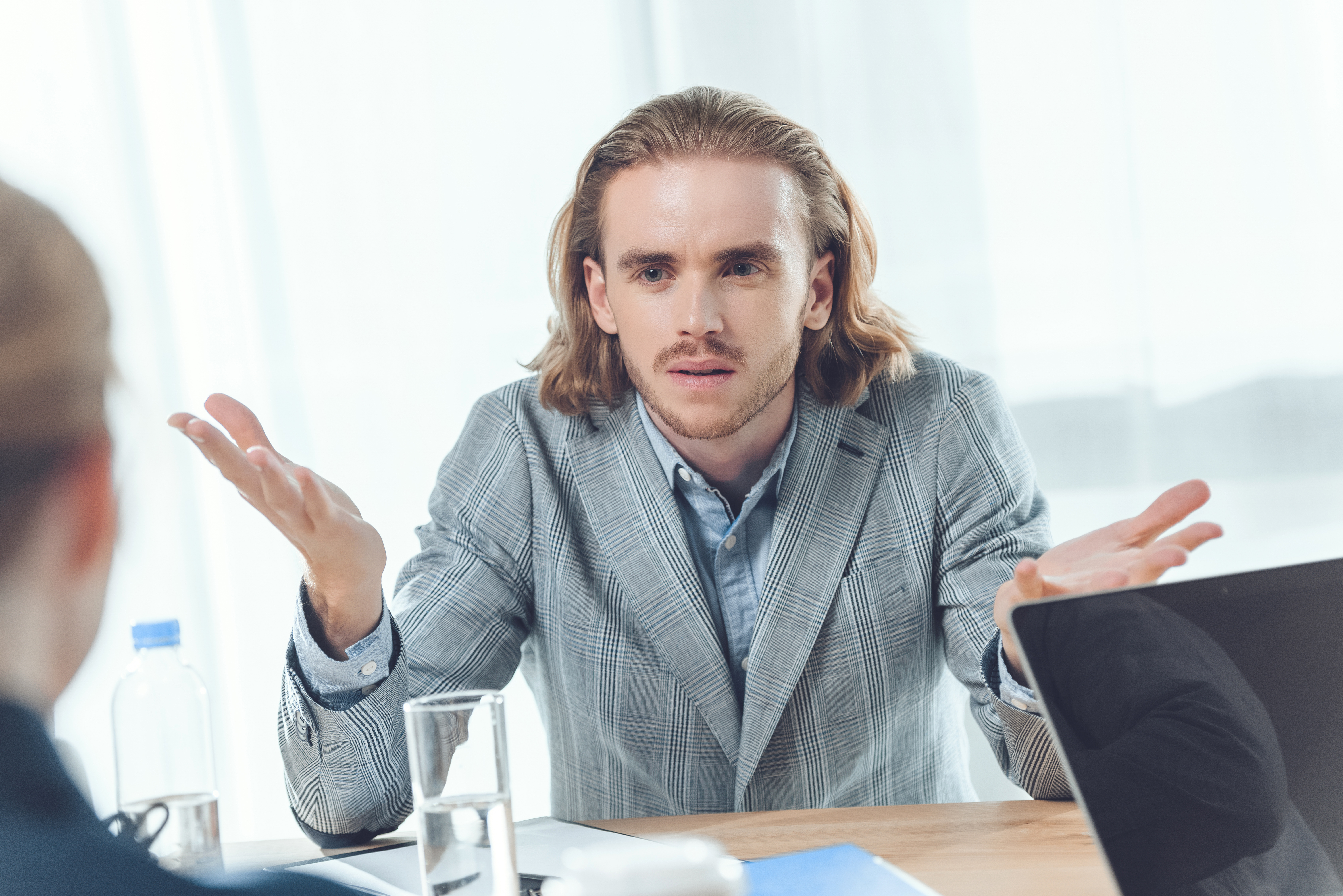 Confused employee surrounded by legal documents and equity paperwork